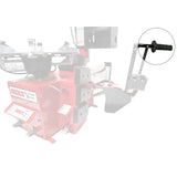 Tire changing machine or wheel balancer, with a red base and various mechanical components.