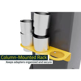 Yellow column-mounted rack holding cylindrical metal adapters.