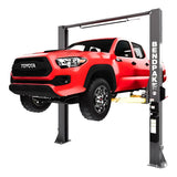 Red Toyota pickup truck lifted on a car lift.