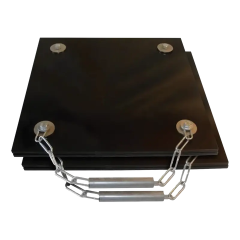 Black metal grease plates connected by chains for truck aligner stability