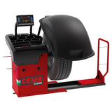 Tire balancing machine with a red base and black wheel cover.