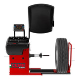 Tire balancing machine with a red base and digital display panel.