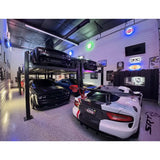 High-end car garage with multiple luxury sports cars and a vehicle lift.