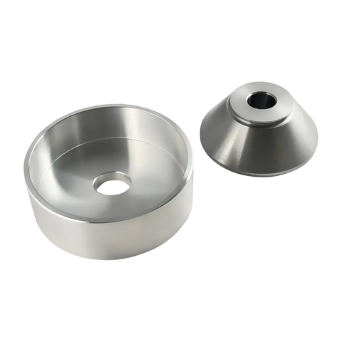 Metallic circular components with central holes, likely machine or hardware parts.