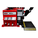 Red industrial tire changing machine with a black platform and safety markings.