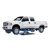 White Ford F-250 pickup truck elevated on a blue hydraulic lift.