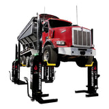 Red dump truck elevated on heavy-duty vehicle lifts.