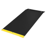 Black exercise mat with a yellow edge at one end.