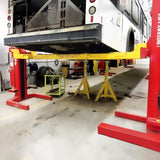 Vehicle lift supporting a fire truck or emergency vehicle in a maintenance bay.