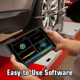 Tablet displaying automotive diagnostic software interface held by a hand near a car wheel.