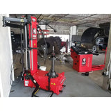 Bright red tire changing machine for automotive service and repair.